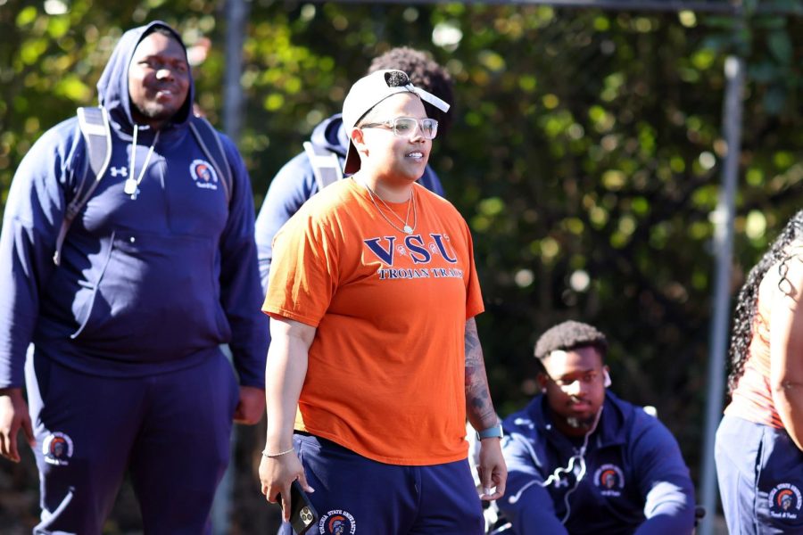 Coach Ashley Dewitt watches her athletes throw the shot put at the Fred Hardy Invitational Track Meet at the University of Richmond. Photo by Virginia Statesman staff. 