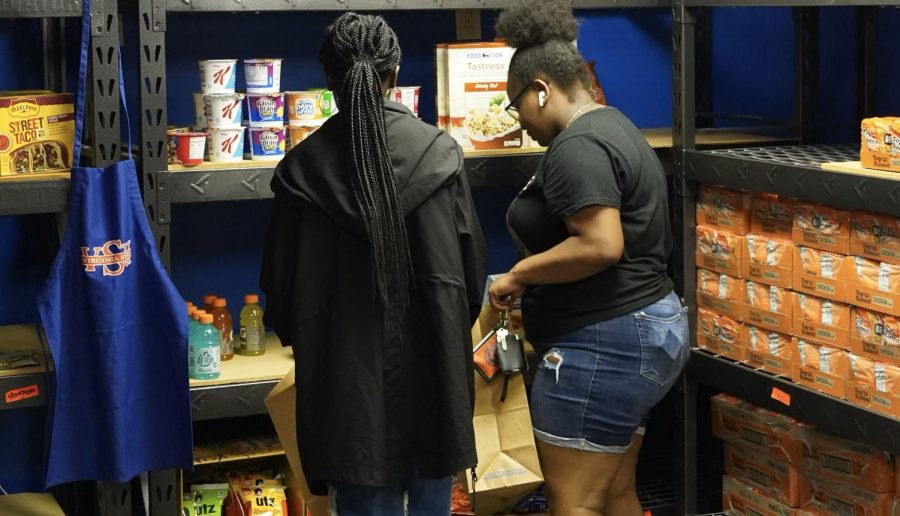 Students check out the food items available in the Troy Store, located in the basement of Foster Hall. The Troy Store is open on Tuesdays and Thursdays from 3 p.m. to 6 p.m. Photo by Treasure Harris.