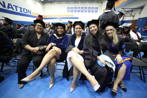 Doctoral graduates from the Class of 2022 prepare for Commencement as they sit together. Staff photo.
