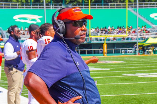 Coach Dr. Henry Frazier III looks on from the sideline at Norfolk State. The Trojans won their road opener 33-24.  Photo by Charnese Small. 