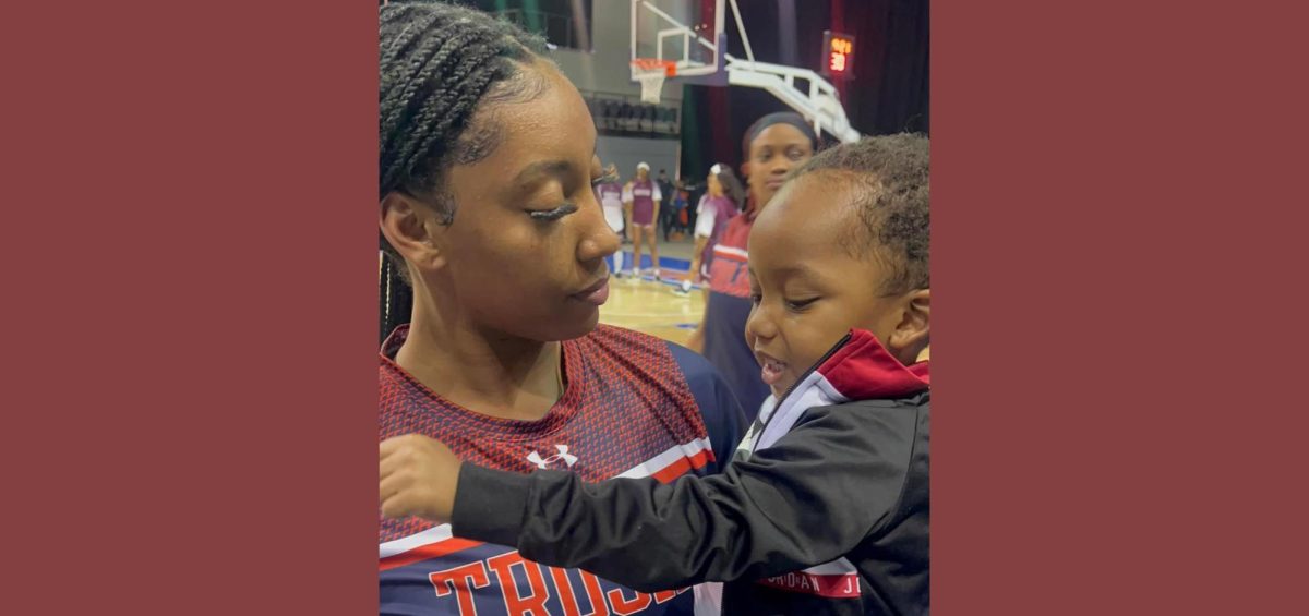 Basketball player Amesha Miller holds her son Avery (2) at the Freedom Classic game on Jan. 20. Photo contributed by Amesha Miller.