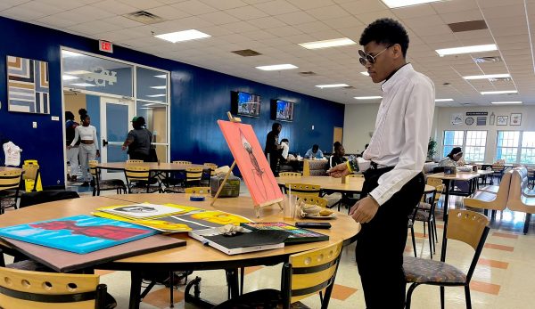 Sophomore Joshua Howell looks over one of his paintings on campus at Virginia State University.