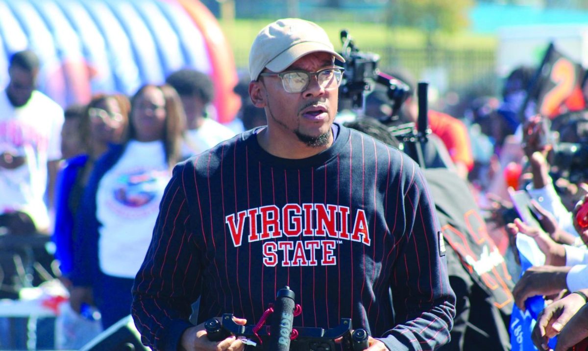 Multimedia content creator Parris Bowles stalks the sidelines of a home football game with his iPhone and rig cage in hand. Bowles has deep family connections to Virginia State University, as well as being a graduate himself. Contributed photo.
