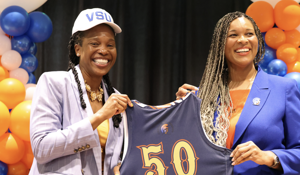 Coach Millette Green receives 
an honorary jersey from 
Associate VP for Intercollgiate 
Athletics Tiffani-Dawn B. Sykes celebrating the announcement 
of her position as head coach.
Photo by staff.